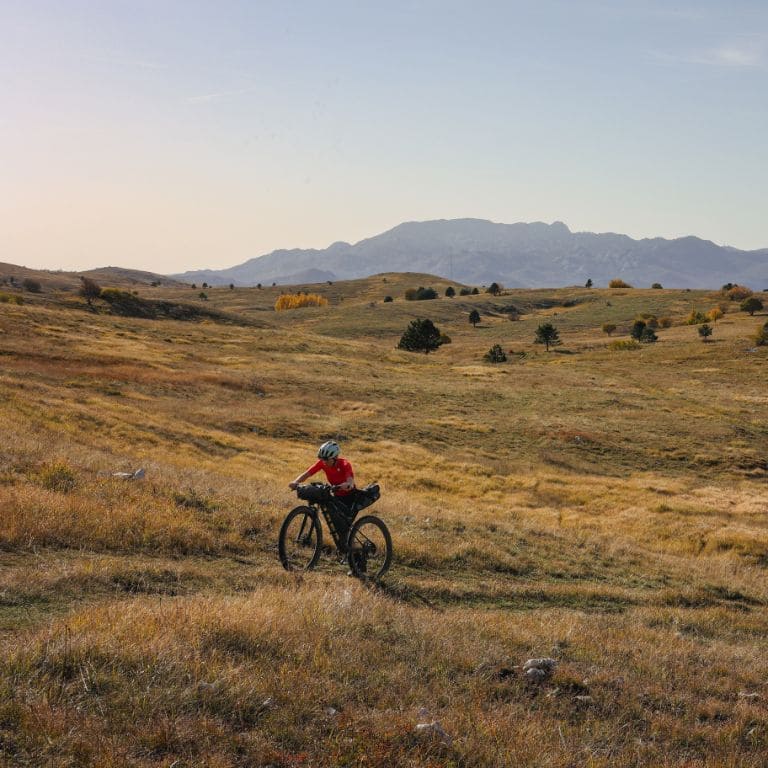 cyclist bikepacking in a mountain landscape