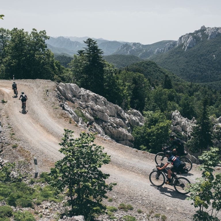 mountain landscape with gravel cyclists